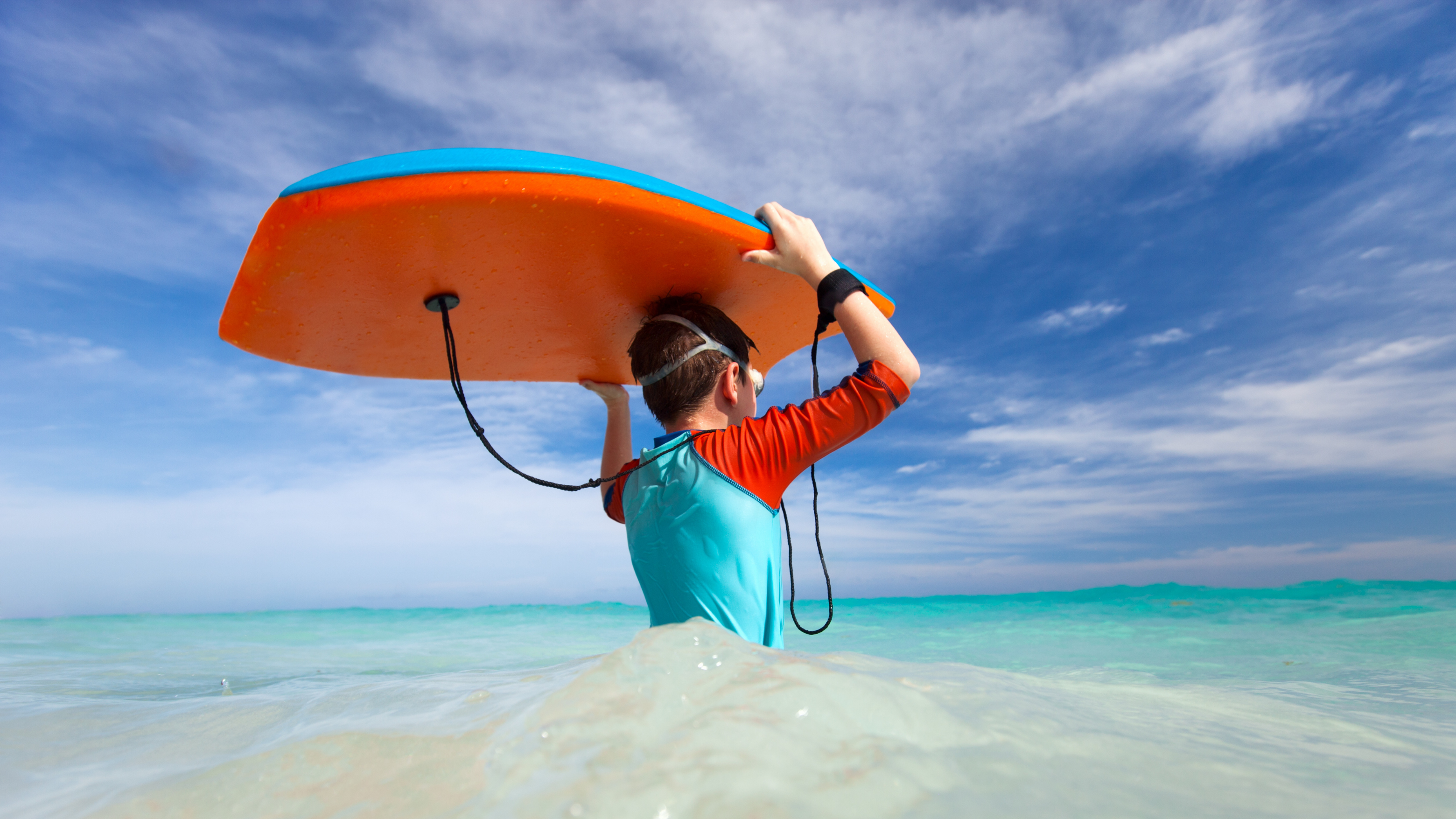 Blog11 Image: Boy entering the sea to boogieboard