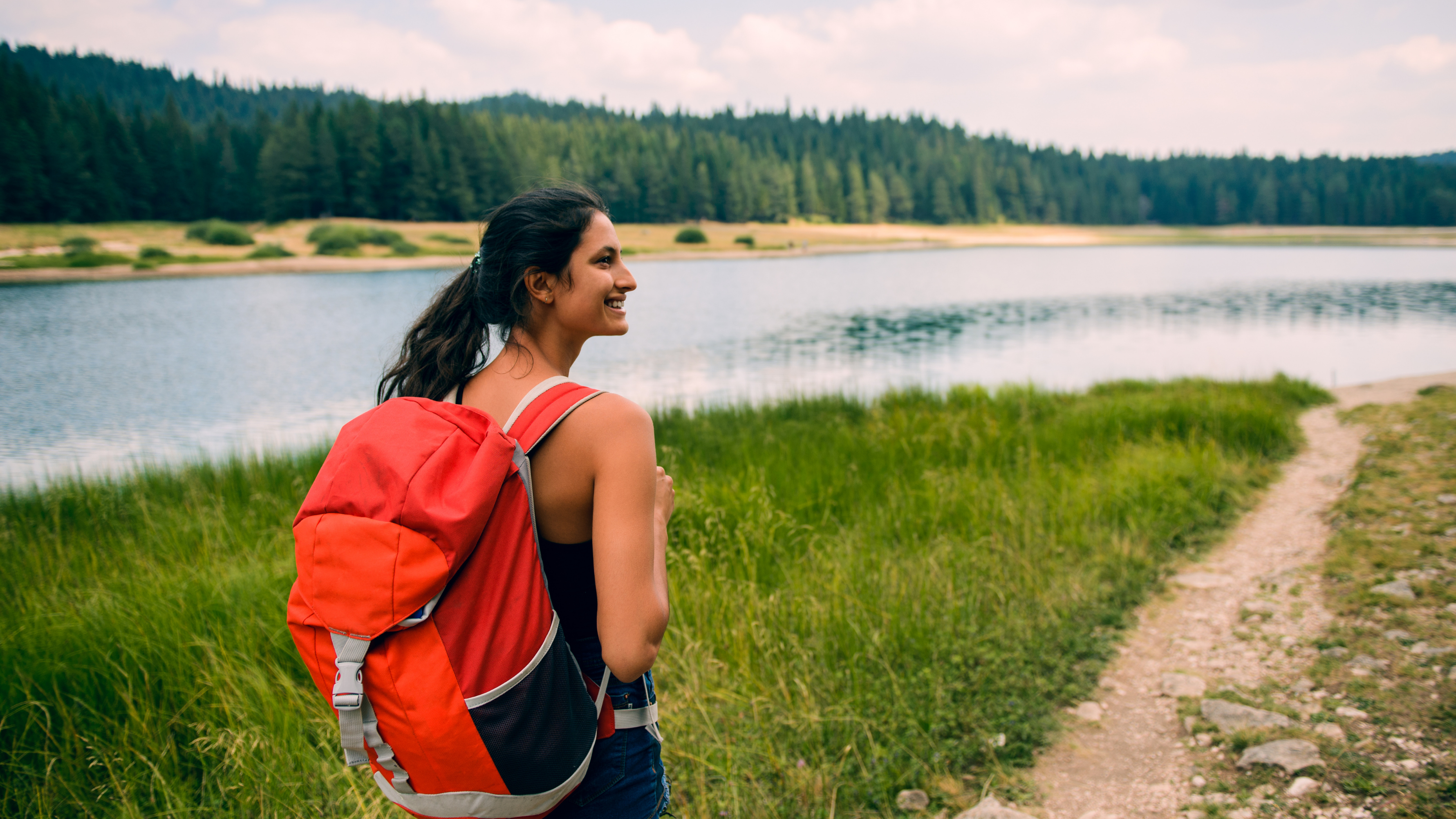 Blog9 Image: Woman hiking alone by a lake